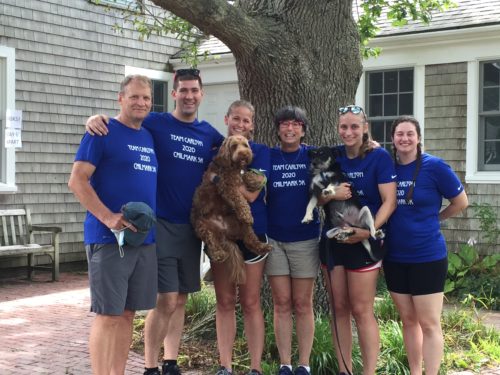 Lauren appears with her family in matching tee shirts with their two dogs